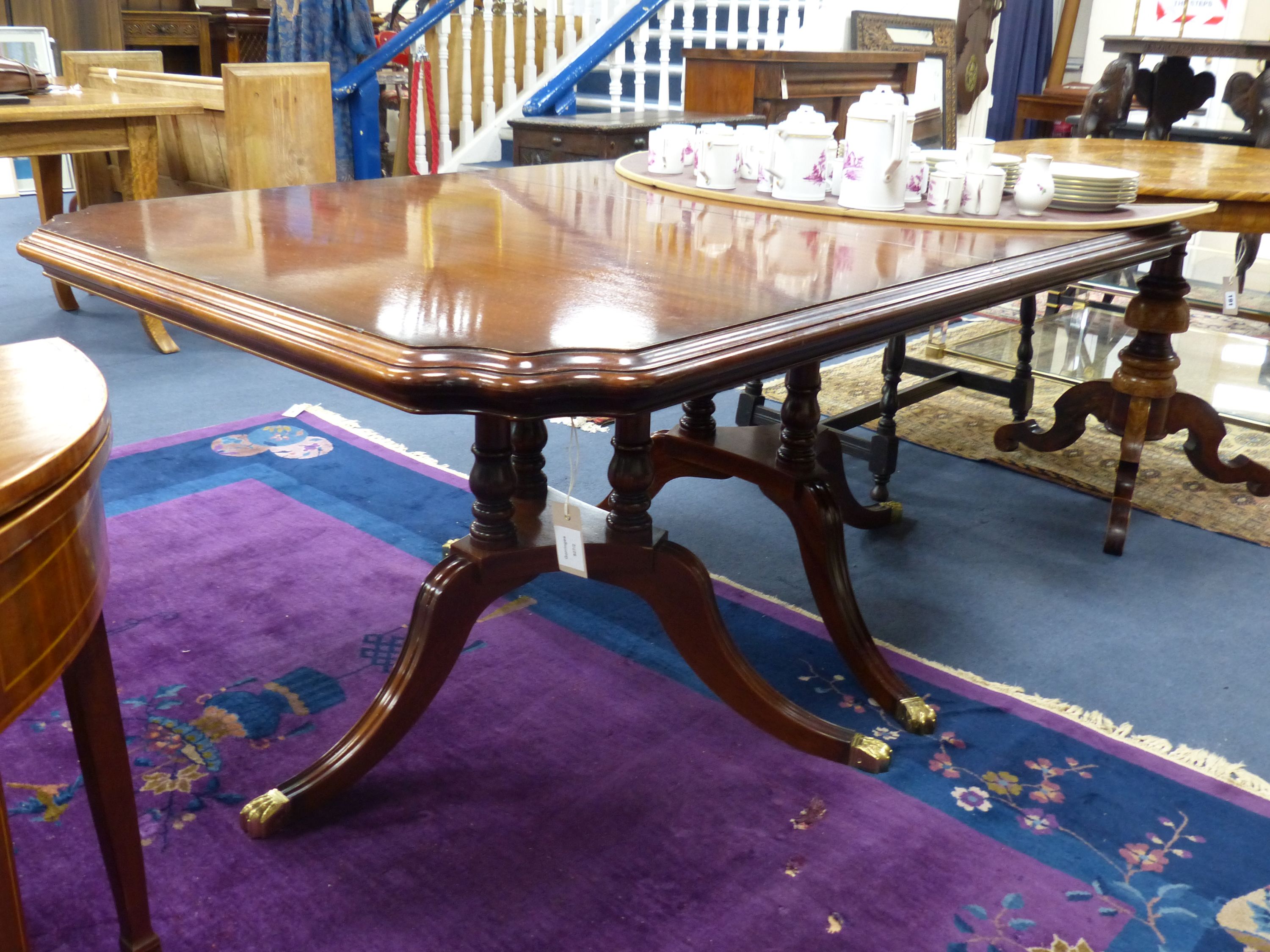 A Harrod's Regency style twin tri-pillar mahogany extending dining table, length 166cm, depth 108cm, height 72cm